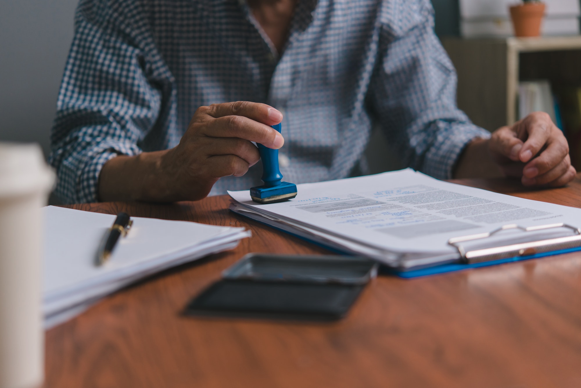 Hand man stamping documents notary public