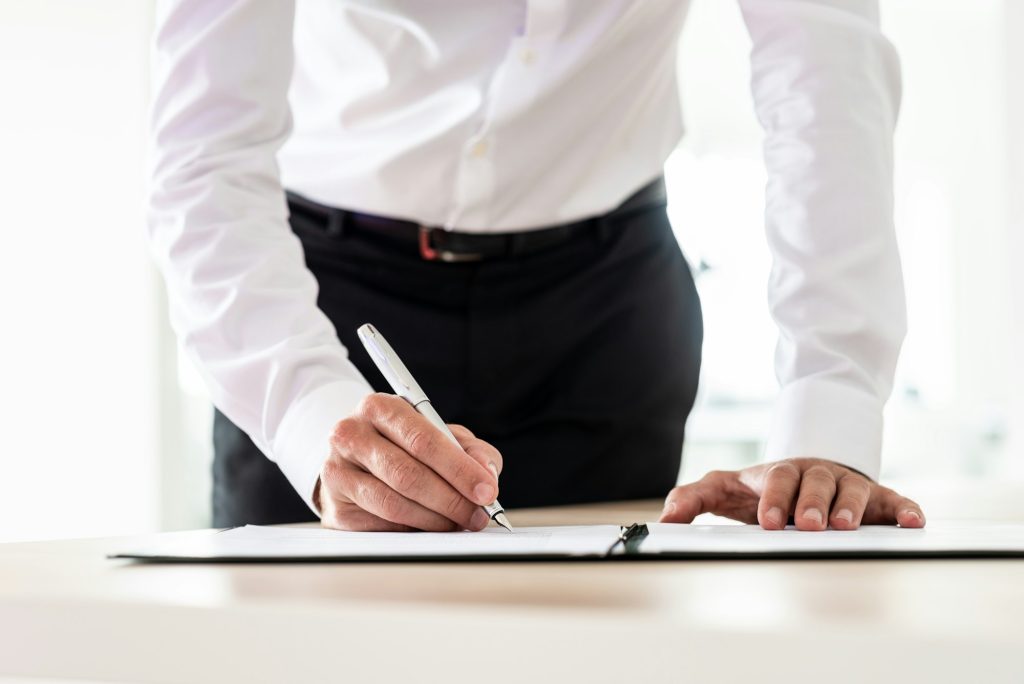 Lawyer signing an important document