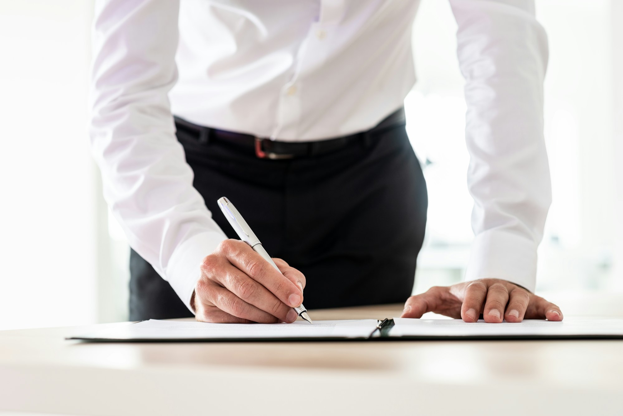 Lawyer signing an important document